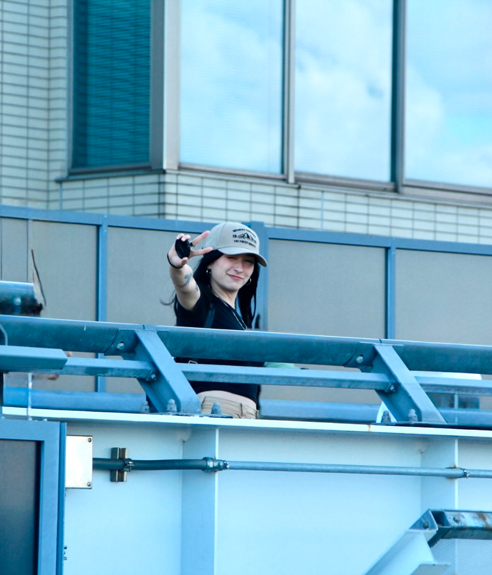 Angie Ciro leaning on a blue metal railing